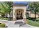 Inviting clubhouse entrance with stone accents, an arched doorway, elegant lighting and manicured landscaping at 4400 S Jones Blvd # 2103, Las Vegas, NV 89103