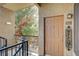 Inviting front entrance with a welcome sign, exterior lighting, and a view of lush greenery at 4400 S Jones Blvd # 2103, Las Vegas, NV 89103