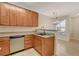 Bright open kitchen with stainless dishwasher, wood cabinets and neutral granite countertops at 4400 S Jones Blvd # 2103, Las Vegas, NV 89103