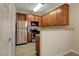 Contemporary kitchen with wood cabinets, stainless steel appliances, and bar seating at 4400 S Jones Blvd # 2103, Las Vegas, NV 89103