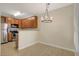 Open kitchen with stainless steel appliances, wood cabinetry, and a breakfast bar overlooking the dining area at 4400 S Jones Blvd # 2103, Las Vegas, NV 89103