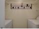 In-unit laundry room with wire shelves and hooks for hanging clothes at 4400 S Jones Blvd # 2103, Las Vegas, NV 89103