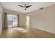 Bright living room with sliding glass door to balcony and modern ceiling fan at 4400 S Jones Blvd # 2103, Las Vegas, NV 89103
