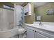 Well-lit bathroom featuring a shower-tub combo and a white vanity with storage at 4804 Portola Vista Ave, Las Vegas, NV 89139