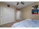 Bedroom featuring carpeted floors, ceiling fan, closet and ample natural light at 4804 Portola Vista Ave, Las Vegas, NV 89139
