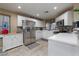 Bright kitchen features stainless steel appliances, white cabinets, and tile backsplash at 4804 Portola Vista Ave, Las Vegas, NV 89139