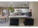 Modern kitchen featuring stainless steel appliances, white cabinetry and dining area at 4804 Portola Vista Ave, Las Vegas, NV 89139