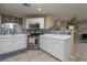 Well-lit kitchen with stainless appliances, mosaic backsplash, and bar seating at 4804 Portola Vista Ave, Las Vegas, NV 89139