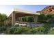A covered, stone-columned exterior with desert landscaping and mountain backdrop at 6 Harlow View Ct # 18, Henderson, NV 89012