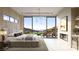Bright main bedroom boasts a fireplace, modern light fixture, and a balcony with scenic views at 6 Harlow View Ct # 18, Henderson, NV 89012