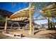 Community playground shaded by modern canopies and surrounded by desert landscaping at 6 Harlow View Ct # 18, Henderson, NV 89012