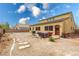 View of the home's back exterior with patio seating and a large, open gravel area at 6636 Brent Scott St, North Las Vegas, NV 89086