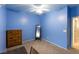 Blue bedroom with a dresser, mirror, desk, and chair for a cozy and functional space at 6636 Brent Scott St, North Las Vegas, NV 89086