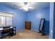 Blue bedroom with a desk, dresser, and mirror providing a calm and functional space at 6636 Brent Scott St, North Las Vegas, NV 89086