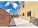 Side view of the home shows a long concrete driveway with a secure gate and ample parking at 6636 Brent Scott St, North Las Vegas, NV 89086