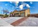 Exterior view showcasing a two-car garage and gated gravel driveway at 6636 Brent Scott St, North Las Vegas, NV 89086