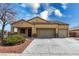 Inviting single-story home featuring a two-car garage and desert landscaping at 6636 Brent Scott St, North Las Vegas, NV 89086