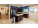 Modern kitchen featuring stainless steel appliances, an island, and tile flooring at 6636 Brent Scott St, North Las Vegas, NV 89086