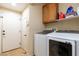 Laundry room with appliances, storage, and tile floors at 6636 Brent Scott St, North Las Vegas, NV 89086