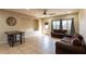 Spacious living room featuring tile flooring, a ceiling fan, multiple sofas, and natural light from the windows at 6636 Brent Scott St, North Las Vegas, NV 89086