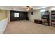 Spacious loft area with plush carpet and a ceiling fan at 6636 Brent Scott St, North Las Vegas, NV 89086