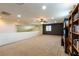 Loft space with media storage, neutral carpet, and ceiling fan at 6636 Brent Scott St, North Las Vegas, NV 89086
