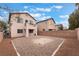 Large backyard with gravel, sturdy block wall and two-story home view at 7013 Pacific Coast St, Las Vegas, NV 89148