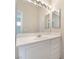 Bright bathroom featuring a large vanity, mirror, and modern fixtures at 7013 Pacific Coast St, Las Vegas, NV 89148