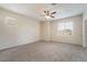 Neutral bedroom with a ceiling fan and ample natural light at 7013 Pacific Coast St, Las Vegas, NV 89148