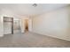 Spacious carpeted bedroom with mirrored closet doors and neutral walls, perfect for personalization at 7013 Pacific Coast St, Las Vegas, NV 89148