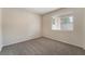 Cozy bedroom with carpet, a window and soft natural light filtering through the blinds at 7013 Pacific Coast St, Las Vegas, NV 89148