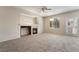 Inviting living area featuring a fireplace, neutral decor, and ample natural light streaming through the windows at 7013 Pacific Coast St, Las Vegas, NV 89148
