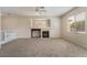Upstairs living room featuring a fireplace and large windows offering plenty of natural light in a neutral color palette at 7013 Pacific Coast St, Las Vegas, NV 89148