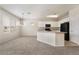 Bright kitchen features white cabinets and a center island with bar seating at 7013 Pacific Coast St, Las Vegas, NV 89148