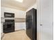 Efficient kitchen featuring white cabinets and contrasting black appliances at 7013 Pacific Coast St, Las Vegas, NV 89148