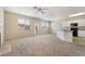 Second floor living room seamlessly integrates with the kitchen and dining area, featuring abundant natural light at 7013 Pacific Coast St, Las Vegas, NV 89148
