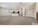 Open living space with a modern kitchen and comfortable carpet at 7013 Pacific Coast St, Las Vegas, NV 89148