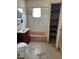 Bathroom with pink bathtub, basic toilet, and open shelved cabinet at 717 Madison Ave, Las Vegas, NV 89106
