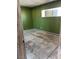 Green bedroom with covered window and worn-out floor showing damage at 717 Madison Ave, Las Vegas, NV 89106