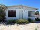 Exterior of home with barred windows and minimal landscaping in need of repair at 717 Madison Ave, Las Vegas, NV 89106