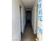 Hallway with multiple doors and a light fixture on the ceiling, in need of repair at 717 Madison Ave, Las Vegas, NV 89106