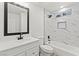 This bathroom features marble-style shower and flooring, modern black fixtures, and a vanity with storage at 724 N 9Th St, Las Vegas, NV 89101