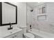 Clean bathroom featuring marble tiling, a modern tub, and sleek black fixtures at 724 N 9Th St, Las Vegas, NV 89101
