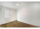 This bedroom features new brown carpet, fresh white walls, and a sunny window at 724 N 9Th St, Las Vegas, NV 89101