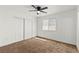 This bedroom features new brown carpet, fresh white walls, a sunny window, and closet with sliding doors at 724 N 9Th St, Las Vegas, NV 89101