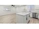 Kitchen features white cabinets, quartz countertops, stainless appliances, and island, providing ample space and modern amenities at 724 N 9Th St, Las Vegas, NV 89101