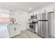 Well-lit kitchen featuring stainless steel appliances, white cabinets, and wood-look floors at 724 N 9Th St, Las Vegas, NV 89101