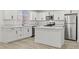Kitchen features white cabinets, quartz countertops, stainless appliances, and island, providing ample space and modern amenities at 724 N 9Th St, Las Vegas, NV 89101