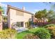 This backyard features artificial turf, mature trees, patio area with outdoor furniture at 7505 Mission Palm St, Las Vegas, NV 89139