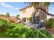 This backyard features artificial turf, mature trees, patio area with outdoor furniture at 7505 Mission Palm St, Las Vegas, NV 89139